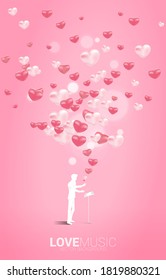 Vector silhouette of conductor standing with piano key with heart balloon flying . Concept background for love song and concert theme.
