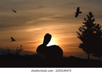 Vector silhouette of forest with rabbir on sunset background. Symbol of hunt and nature.