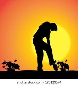 Vector silhouette of a gardener in the garden at sunset.