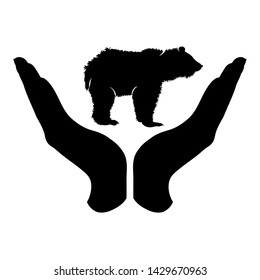 Vector silhouette of a hand in a defensive gesture protecting a bear. Symbol of animal, wild,grizzly,nature, humanity, care, protection.