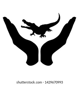 Vector silhouette of a hand in a defensive gesture protecting a crocodile. Symbol of animal, wild, nature, humanity, care, protection.