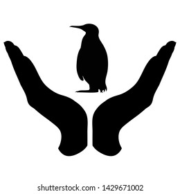 Vector silhouette of a hand in a defensive gesture protecting a penguin. Symbol of animal, wild,nature, humanity, care, protection.