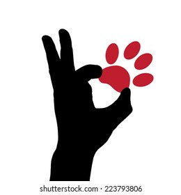 Vector silhouette of a hand which holds the dog's paw.