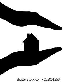 Vector silhouette of a hands with house on a white background.