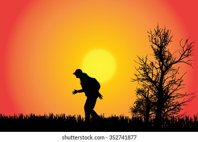 Vector silhouette of a man in the countryside at sunset.