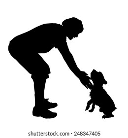 Vector silhouette of a man with a dog on a white background.