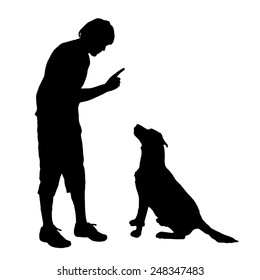 Vector silhouette of a man with a dog on a white background.