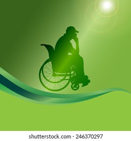 Vector silhouette of a man in a wheelchair on a green background.