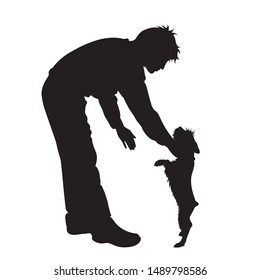 Vector silhouette of man who play with dogs on white background. Symbol of friends and funny activities.