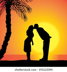 Vector silhouette of people on a beach at sunset.