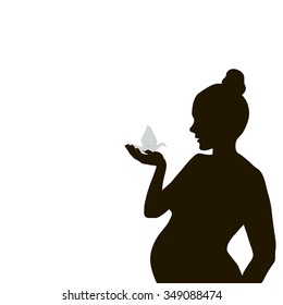 Vector silhouette of a pregnant woman with paper cranes in hand