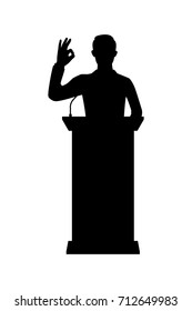 Vector silhouette of a standing businessman on podium. Isolated vector on white background.