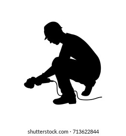 Vector silhouette of a technician with electric grinding metal. Isolated vector on white background.