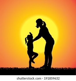 Vector silhouette of a woman with child at sunset.