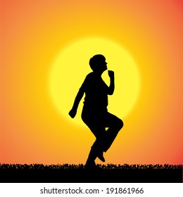Vector silhouette of a woman who is outdoors at sunset.