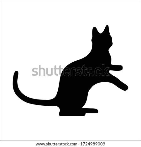 Vector silhouetted cat. The pet is playing. Silhouettes of cats in a playful mood, the kitten stands on its hind legs.