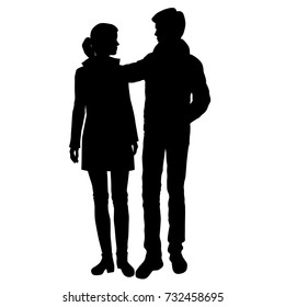 Vector silhouettes of man and woman standing, couple, black color, isolated on white background