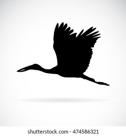 Vector silhouettes of stork flight on white background.