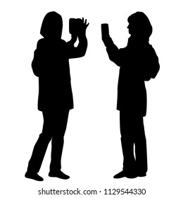 Vector silhouettes women standing with smart phone, business,  people,  black color, isolated on white background