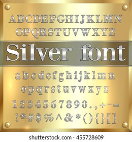 Vector silver coated alphabet letters, digits and punctuation on golden metallic background
