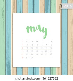 Vector simple modern calendar May 2016 on a colorful wooden texture background. Calligraphy lettering month name