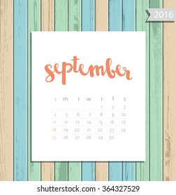 Vector simple modern calendar September 2016 on a colorful wooden texture background. Calligraphy lettering month name