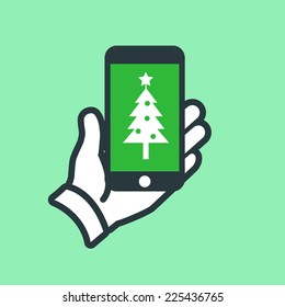 Vector smartphone in hand with christmas tree on screen icon | flat design pictogram isolated on green background