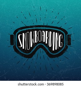 Vector snowboarding label. Goggles and lettering on grunge winter background.