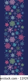 vector Snowflakes On Night Sky Vertical Seamless Pattern ornament with drawn snowflakes on dark night sky background.
