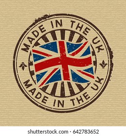 Vector stamp with flag of GB, circular lettering made in the UK on wooden background