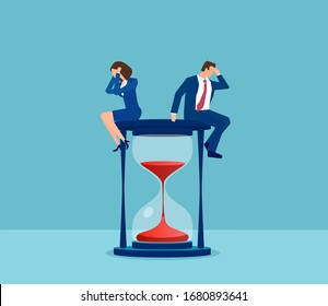 Vector of a stressed businessman and businesswoman sitting on a hourglass 