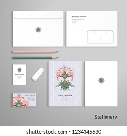 Vector templates. Envelope, cards, business cards, tags, pencils, eraser. Pattern with indian paisley flowers. Top view