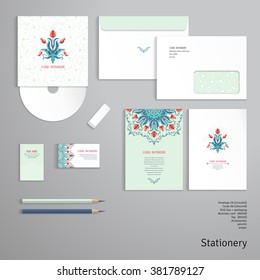 Vector templates. Envelope, cards, business cards, tags, disc with packaging, pencils, eraser. Floral element and ornament with leaves and curls. Round element of tulip flower. 