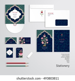 Vector templates. Envelope, cards, business cards, tags, disc with packaging, pencils, eraser. Dark backdrop. Tree of Life and indian decorative frame. Motives of the paintings of ancient fabrics. 