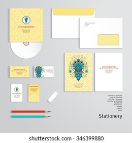 Vector templates with floral pattern with peacock feather. Envelope, cards, business cards, tags, disc with packaging, pencils, eraser.