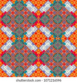 Vector textile print for bed linen, jacket, package design, fabric and fashion concepts. Seamless pattern ethnic design in blue, pink and red colors. Geometric background with tribal tiles.