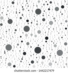 Vector texture of randomly arranged gray circles of various sizes and shades. Circles partially formed up vertically.