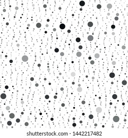 Vector texture of randomly arranged gray circles of various sizes and shades. Circles partially formed up vertically.