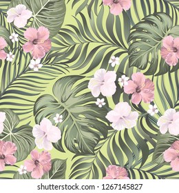 Vector tropical seamless pattern with hibiscus flowers and palm leaves.