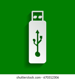 Vector USB flash drive sign. Vector. Paper whitish icon with soft shadow on green background.