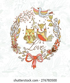 vector Valentine's card with a floral wreath and two cute owls
