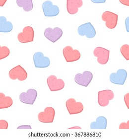 Vector Valentine's seamless pattern with pink, purple and blue sweetheart candies on a white background.