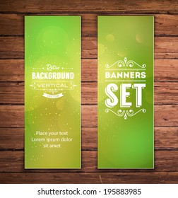 Vector vertical banners with green blurry glittering bokeh background