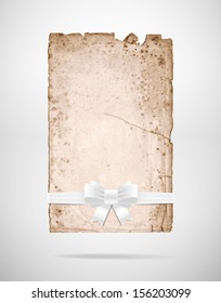 Vector very old rusty torn paper sheet with white silky ribbon bow