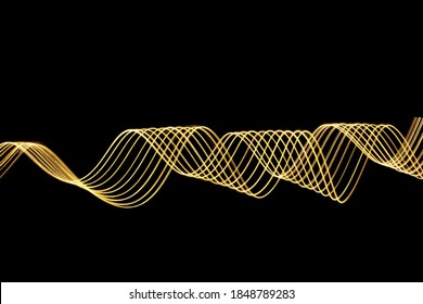 A vector of vibrant gold colour in an abstract swirl swoosh shape, streak of light, against a black background