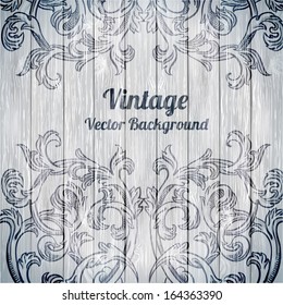 Vector vintage baroque engraving floral scroll filigree design on wood texture
