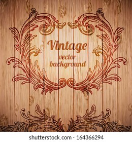 Vector vintage baroque engraving floral scroll filigree design on wood texture