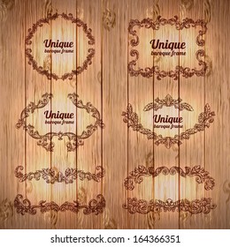 Vector vintage baroque engraving floral scroll filigree design on wood texture