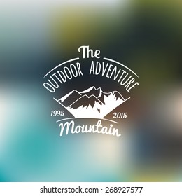 Vector vintage camping logo with mountains. Hand drawn tourist label. Retro hipster emblem or badge of outdoor adventures.
