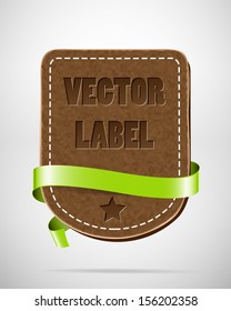 Vector vintage leather badge with green silky ribbon